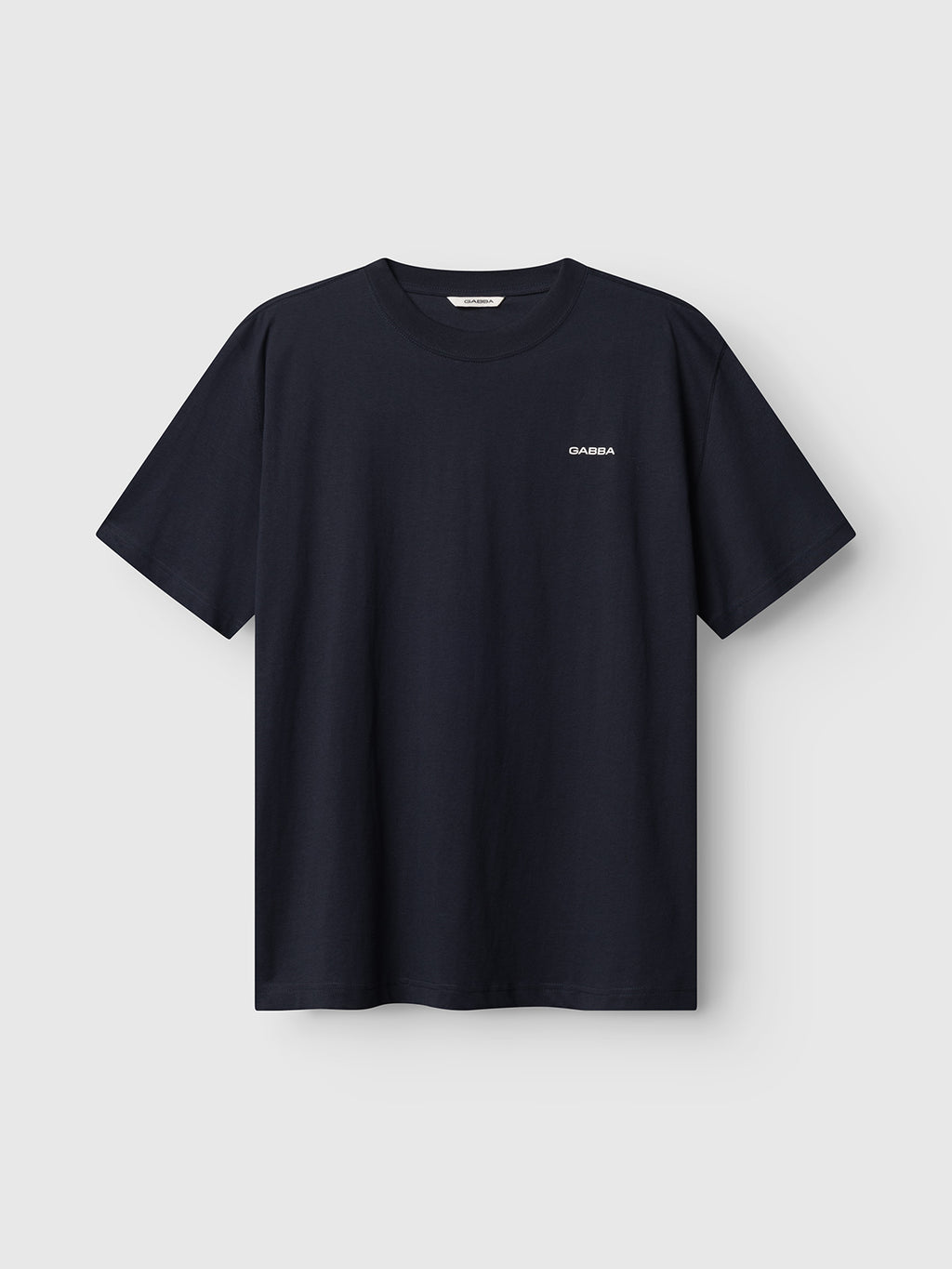 A navy short-sleeve GABnigel Boxy Logo GOTS t-shirt by Gabba, featuring a small white logo on the left chest, displayed against a light gray background.