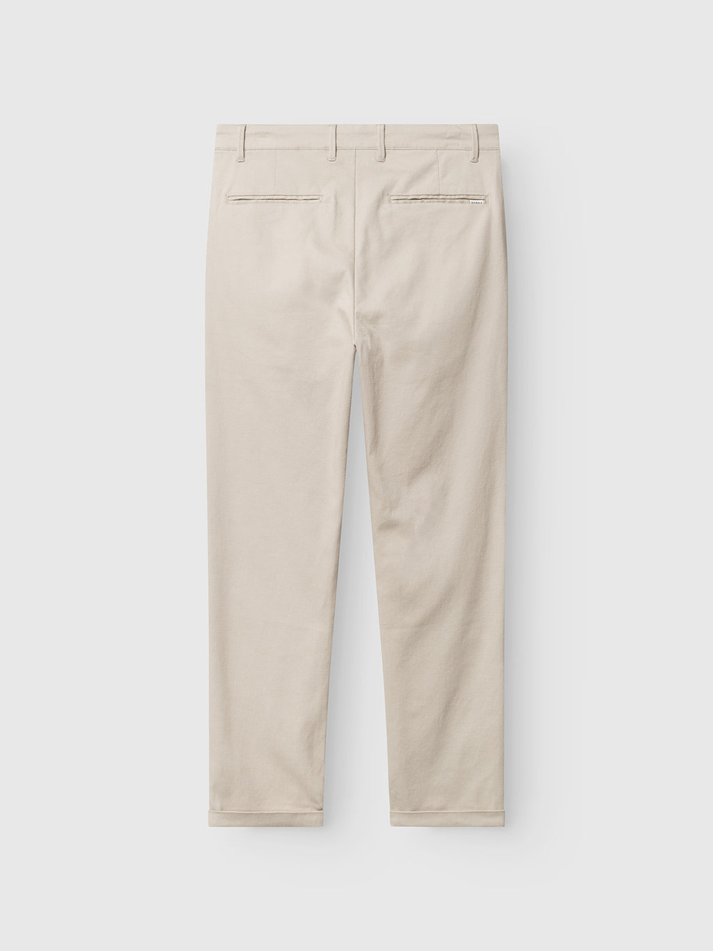 Back view of Gabba GABpaul L.C. Zip Crop Doby Pant in Lt. Sand, featuring belt loops and two back welt pockets, laid flat on a white background.