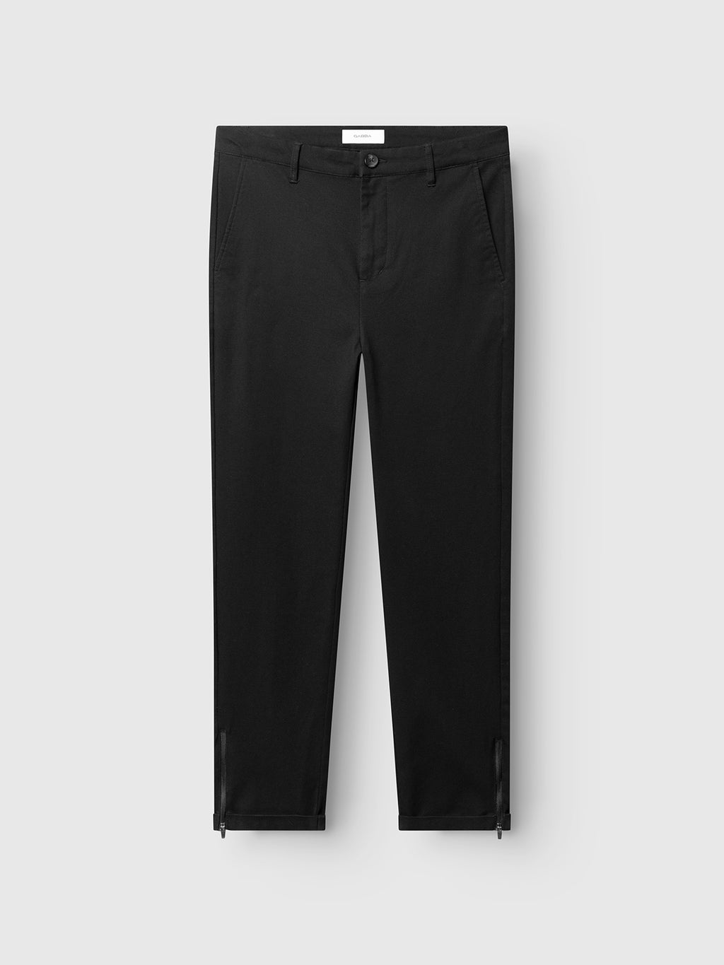 The Gabba GABpaul L.C. Zip Crop Doby Pant in Blue Black features straight legs, front pockets, a button and zipper closure, and small ankle slits, shown against a light gray background.