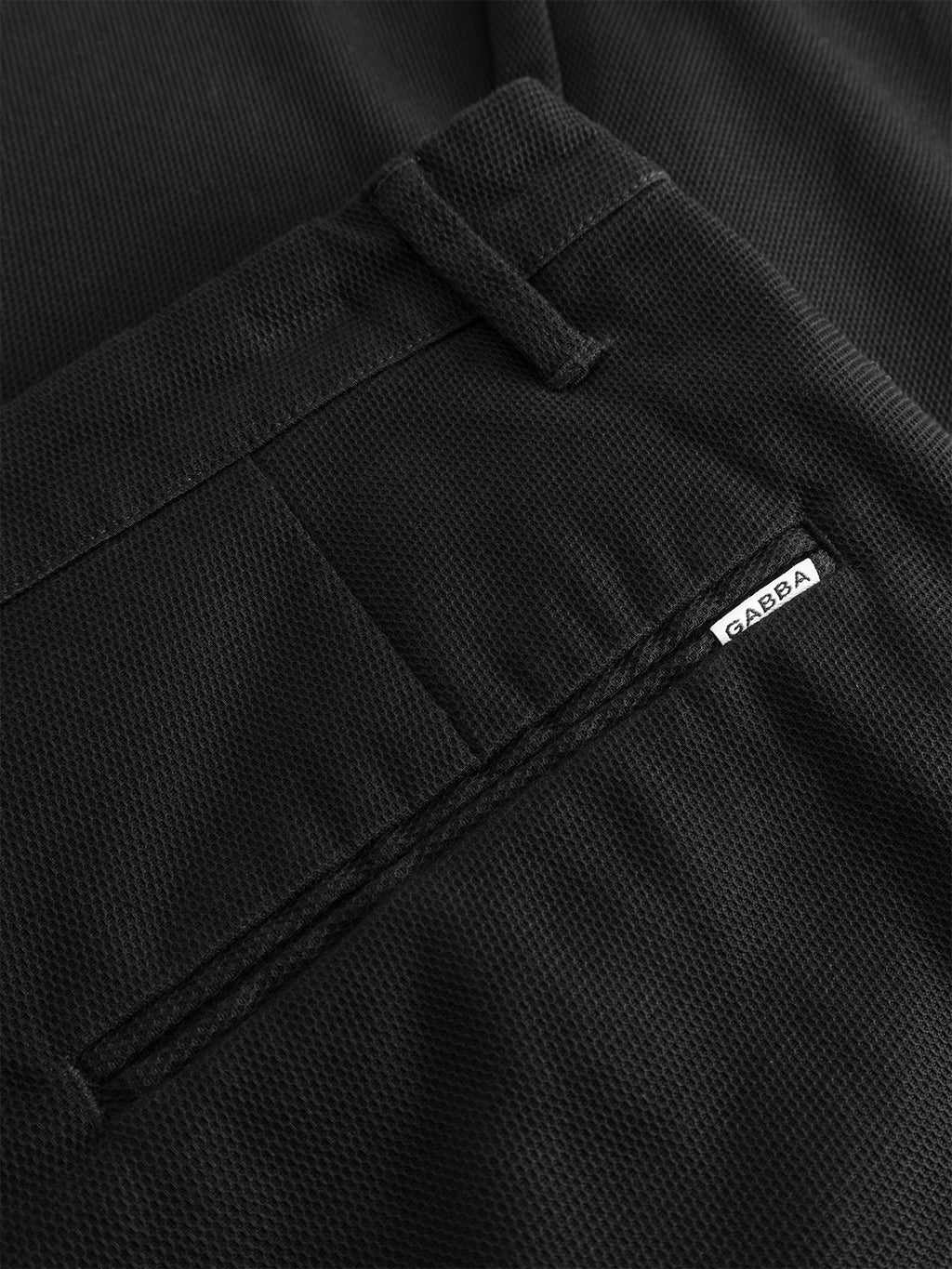 Close-up of the GABpaul L.C. Zip Crop Doby Pant in Blue Black by Gabba, showing the textured fabric, back pocket with a small white 
