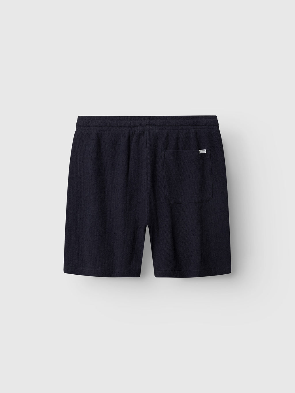 The Gabba GABtommi Towel Shorts in Navy feature an elastic waistband, single back patch pocket, and regular fit terry cotton, shown against a plain light gray background.