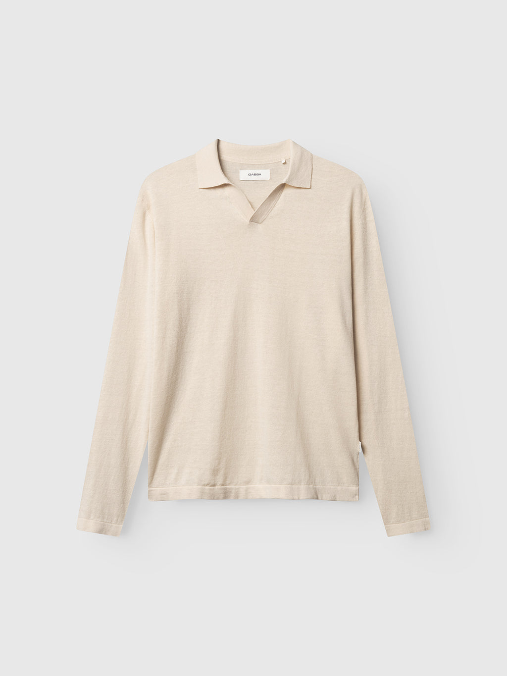 The Gabba GABcross Dush LS Knit - Sand Mel. is a light beige long-sleeve knit polo with a relaxed collar and flat knit texture, showcased against a plain light gray background.