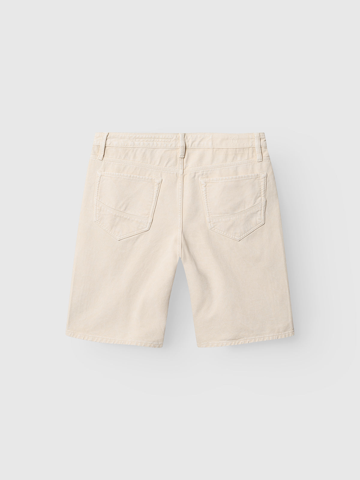 Gabba GABmox Antiq Shorts in Ecru, shown from the back against a light gray background, feature a relaxed fit, two rear pockets, belt loops, and are made from rigid twill fabric with a garment-dyed antique finish.
