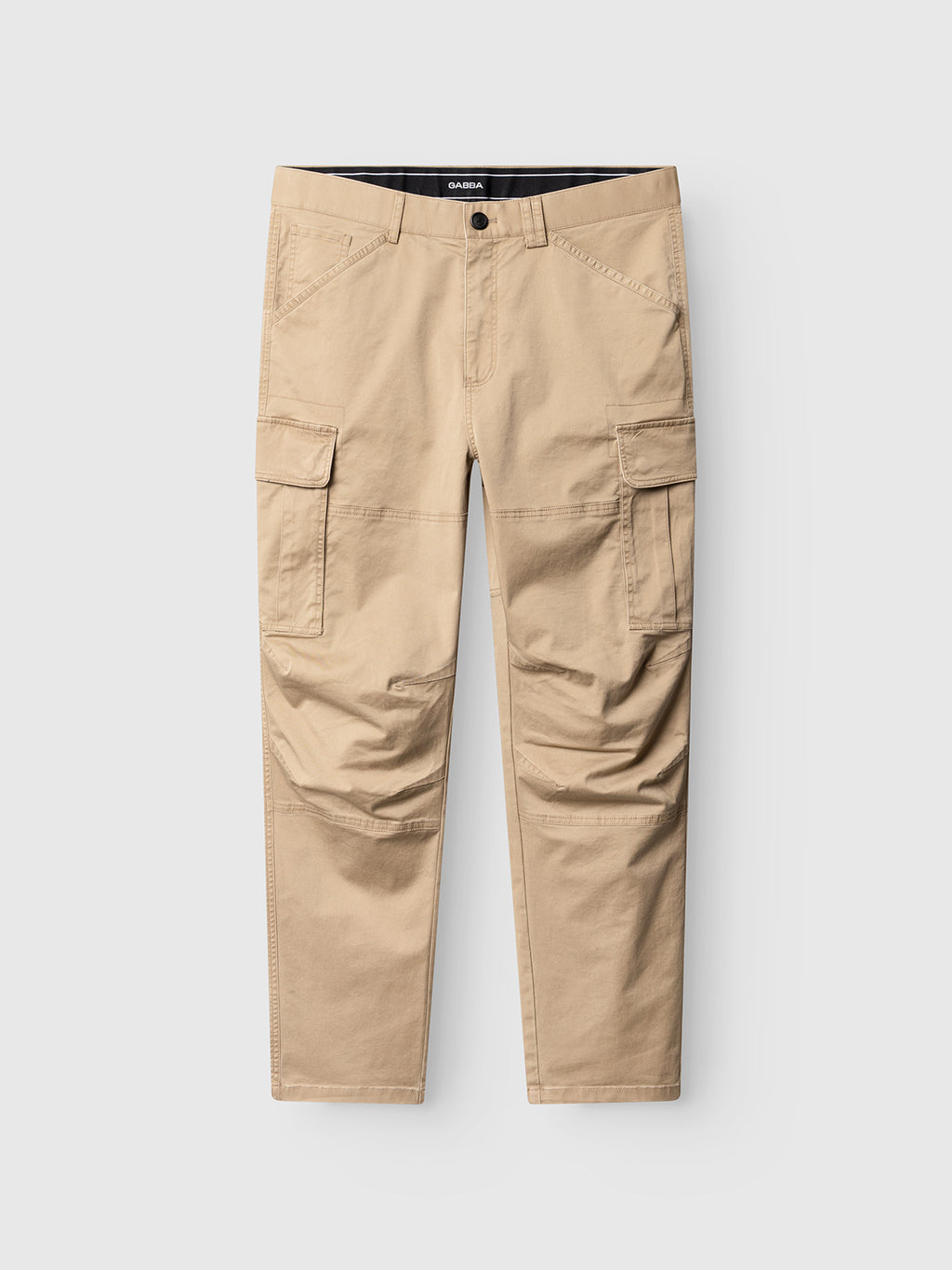 The Gabba GABjoe Vico Cargo Pant in Sand features a tapered fit and multiple pockets, including two large flap side pockets, displayed against a plain white background.