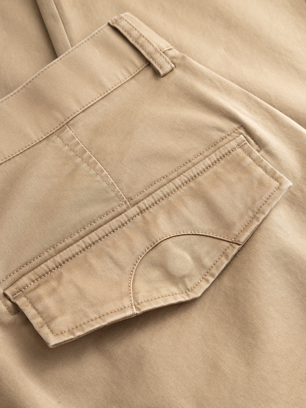 Close-up of Gabba's GABjoe Vico Cargo Pant in Sand, highlighting the back pocket with flap and visible stitching on smooth, slightly shiny cotton stretch fabric for a refined utilitarian look.