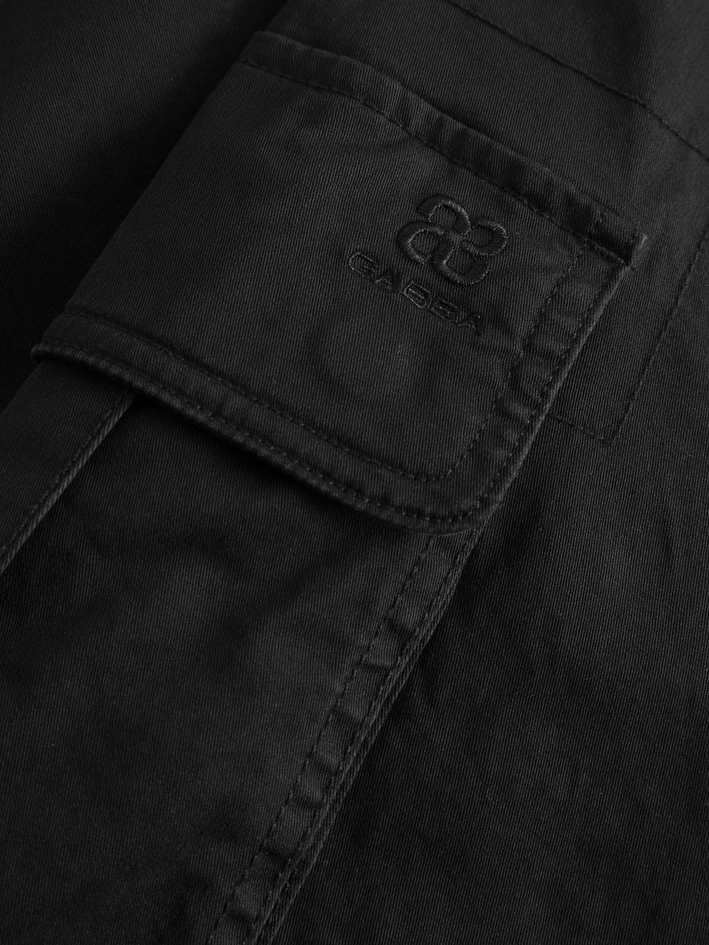 Close-up of a black stretch cotton pocket with visible stitching and an embossed Gabba logo on the flap, designed for GABjoe Vico Cargo Pant - Black.
