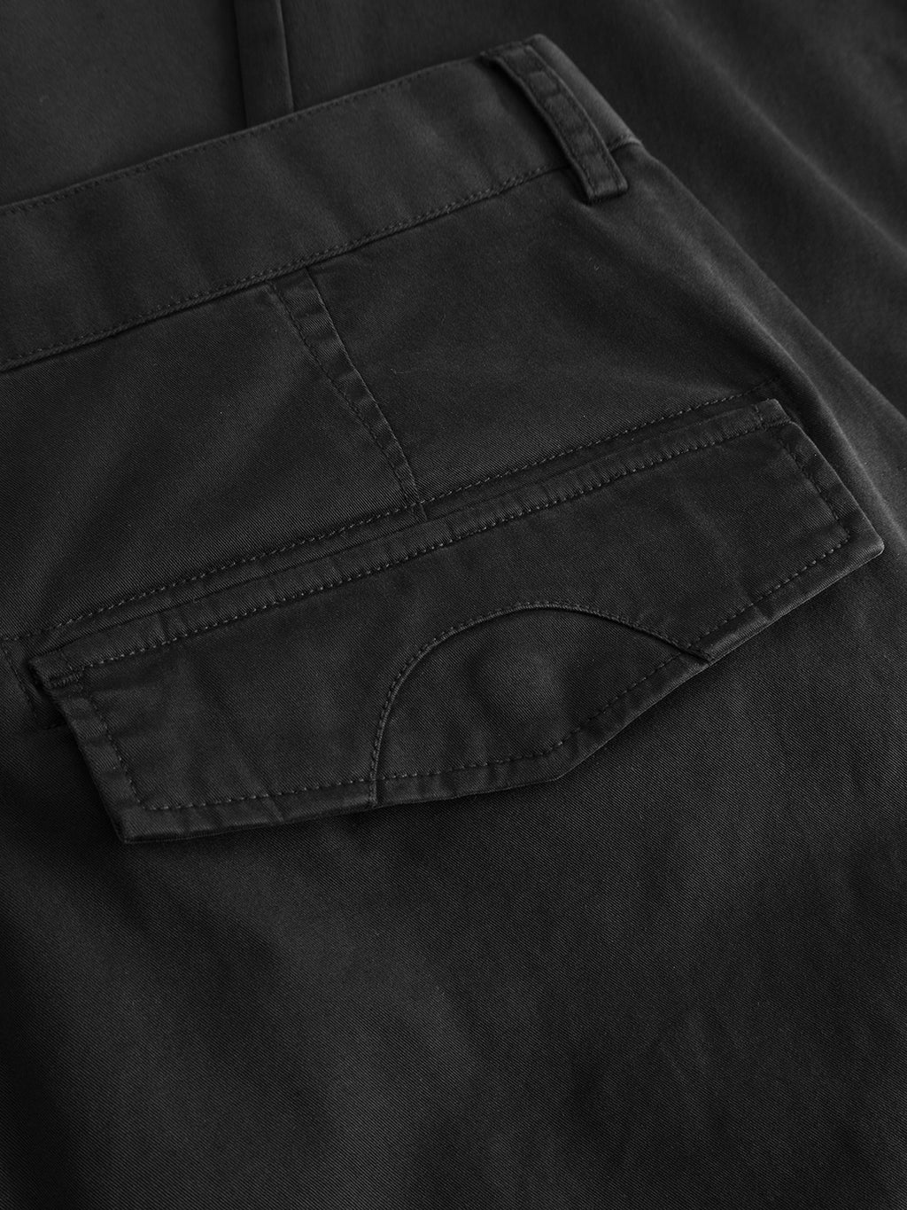 Close-up of the back pocket on the Gabba GABjoe Vico Cargo Pant - Black, highlighting detailed stitching and part of the waistband crafted from stretch cotton.