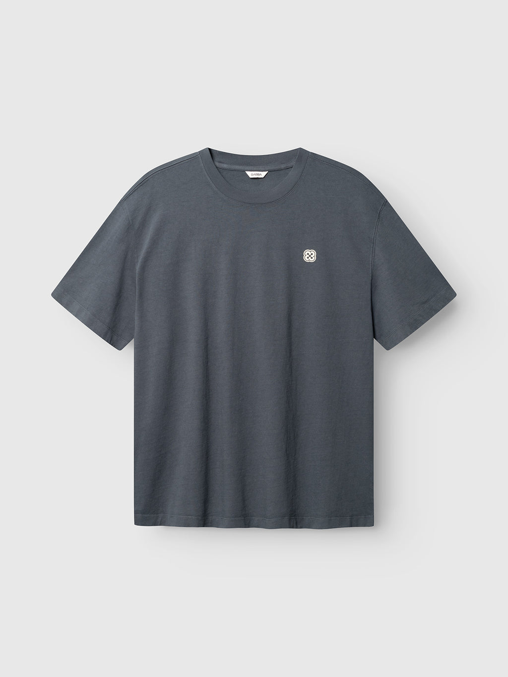 The Gabba GABlegin Wix Chap Boxy Hour SS T-Shirt in Turbulence Blue features short sleeves, heavyweight cotton, and a small white circular logo on the left chest, displayed against a light gray background.