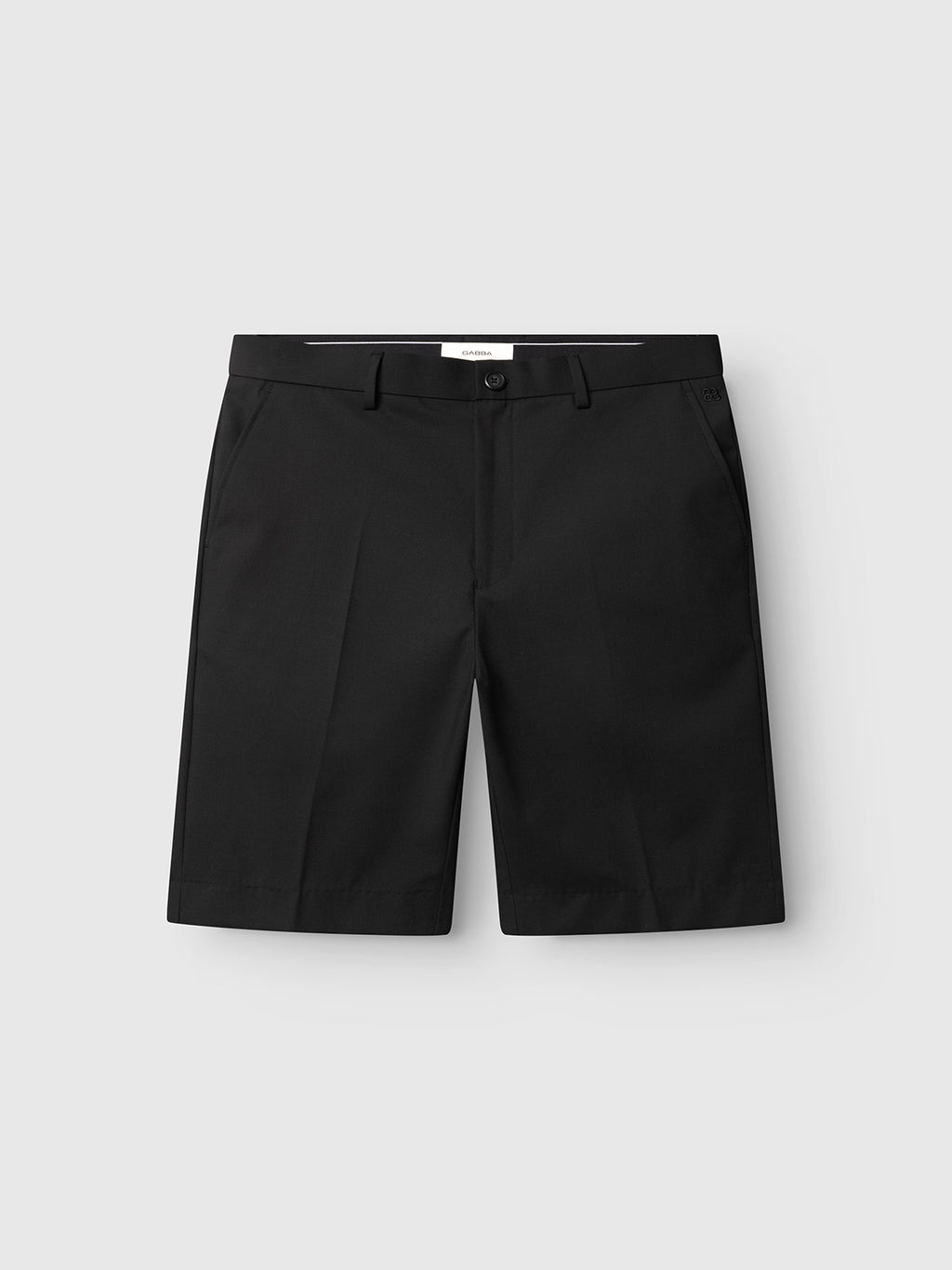 GABjoli Tailor Dressy Shorts by Gabba in black, with button and zip closure, front pockets, belt loops, and brand mark. Refined tailored design presented on a plain light gray background.