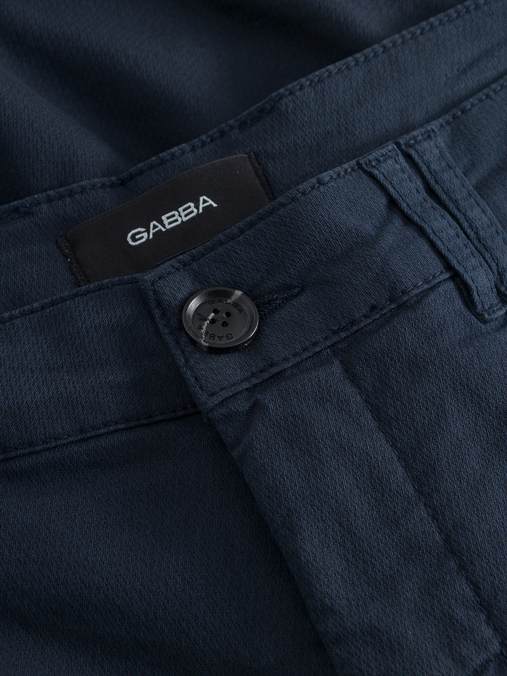 Close-up of the Gabba GABjet K3280 Dale Shorts in navy, featuring a black brand label, button, belt loop, and part of the waistband—these versatile shorts offer smart style and all-day comfort.