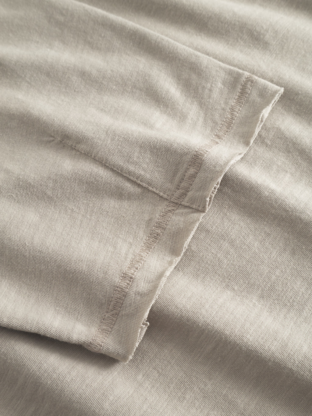 Close-up of Gabba’s GABkostant New SS - Grey Paloma, featuring light beige 100% cotton fabric with visible stitching, textured surface, and detailed construction.
