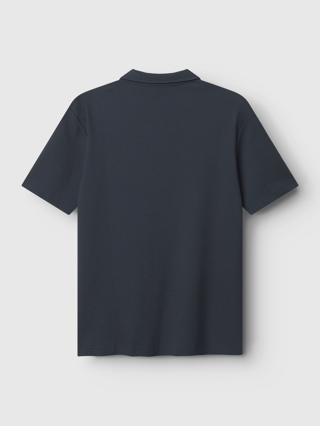 The Gabba GABlio Waff polo shirt in navy, featuring short sleeves and midweight waffle fabric, is shown from the back, laid flat on a light background.