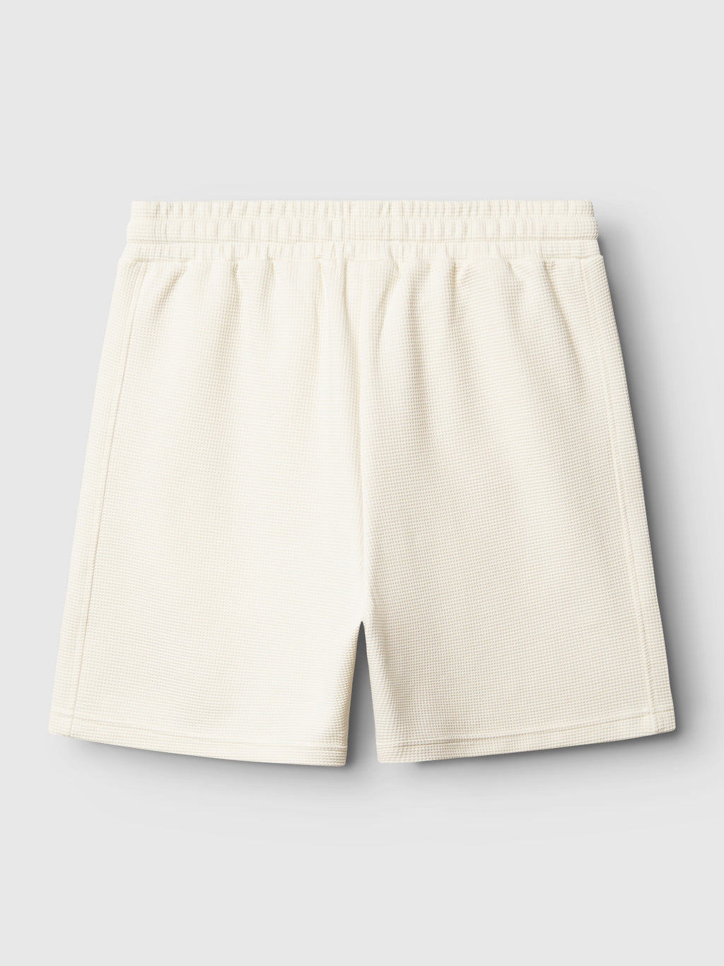 Back view of Gabba’s Tim Waff - Bone White textured shorts with an elastic waistband, shown against a plain light gray background.