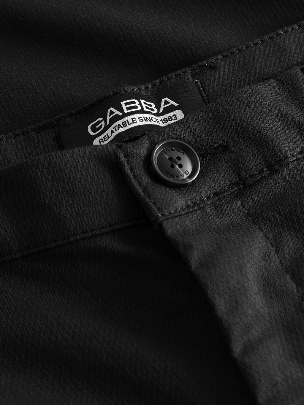 Close-up of Gabba Pisa K3280 Dale Pants in black, highlighting the button, stitching, and GABBA RELATABLE SINCE 1983 label; features a modern tapered fit.