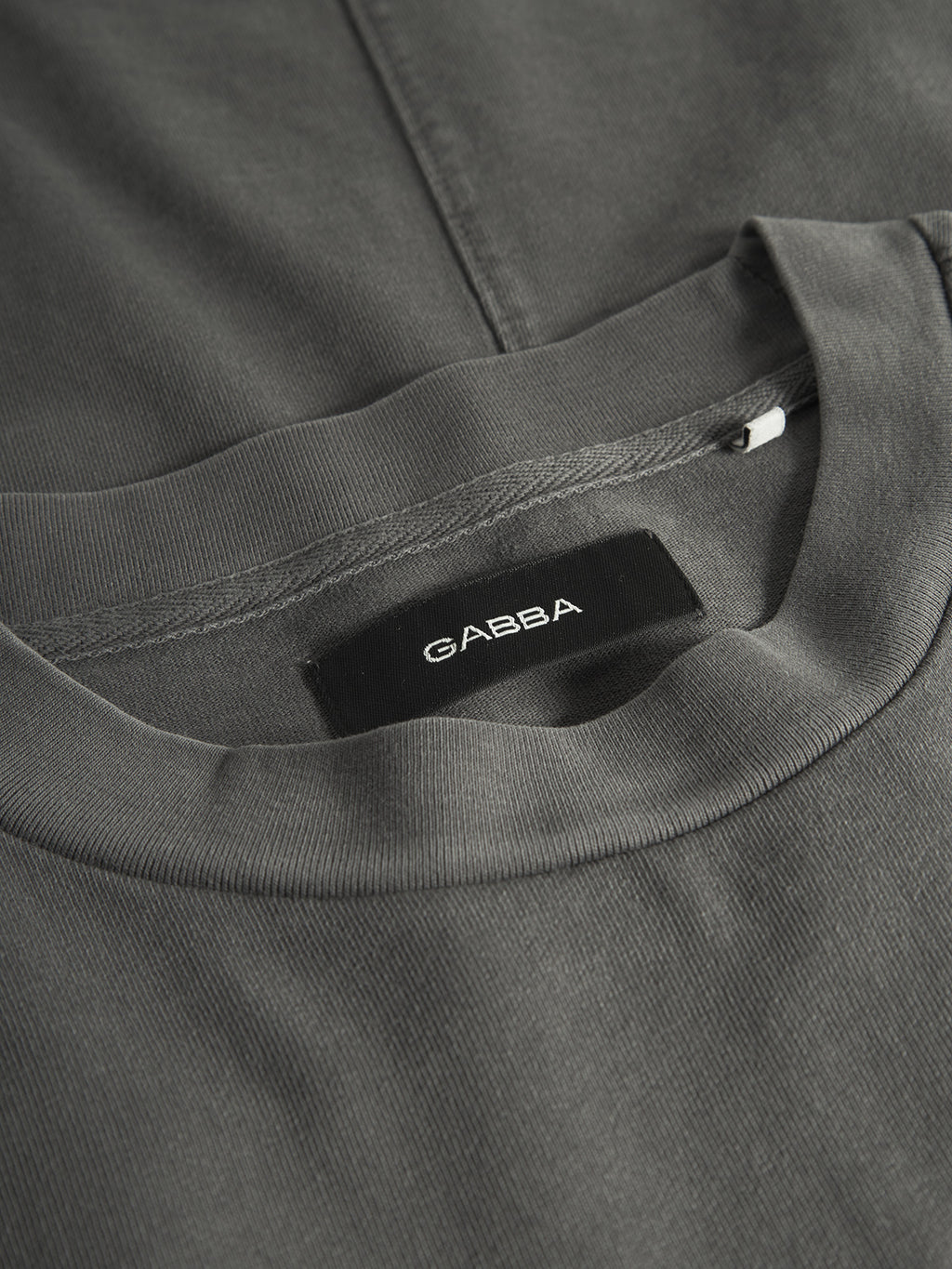 Close-up of the Gabba GABnigel Wix Boxy Hour SS t-shirt in dark grey, featuring heavyweight cotton and a black 