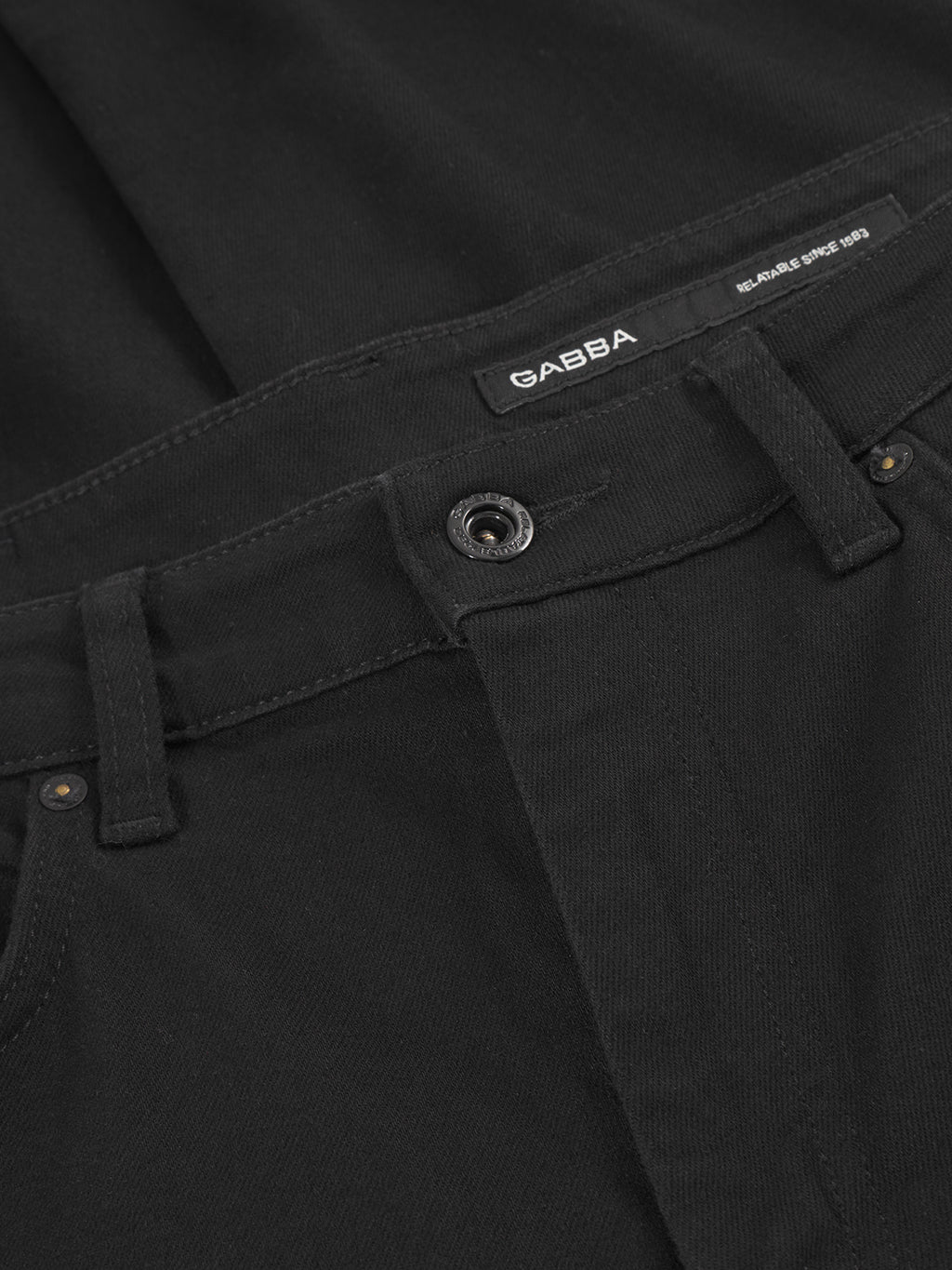 Close-up of GABmarc Sword - Black Denim by Gabba, crafted from intense black denim with a visible button, belt loops, and a small black GABBA label above the waistband for a sharp, clean look.
