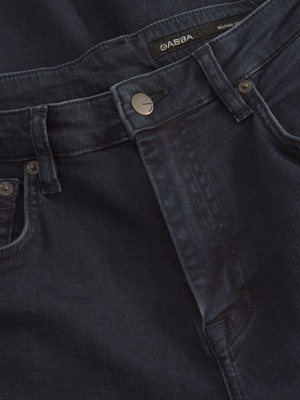 Close-up of the GABmarc Panter - Dark Blue Denim jeans by Gabba, featuring a metal button, belt loops, front pockets, and a visible Gabba label on the waistband.