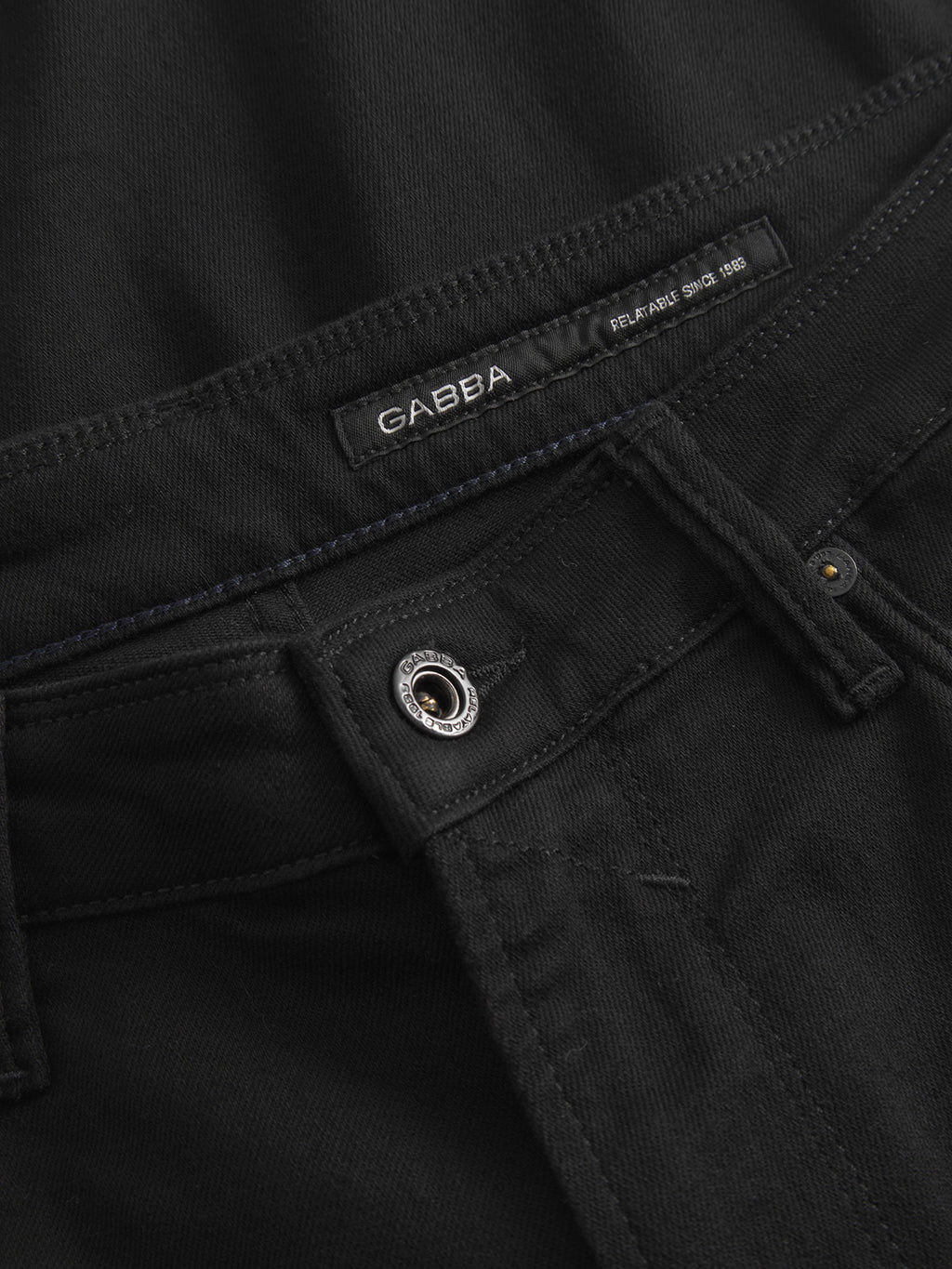 Close-up of the waistband and button area of the GABmax Sword - Black Denim jeans, showing the Gabba brand label stitched inside.