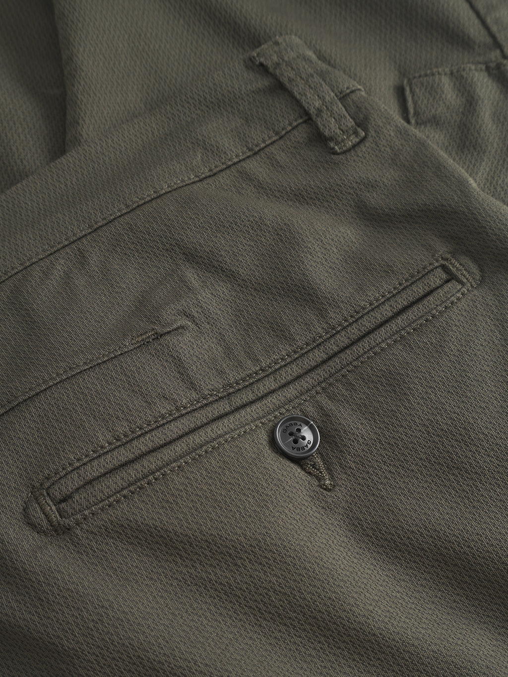 Close-up of the back pocket on Gabba Paul K3280 Cargo Dale - Army slim fit pants, showcasing a single branded button closure and textured fabric.
