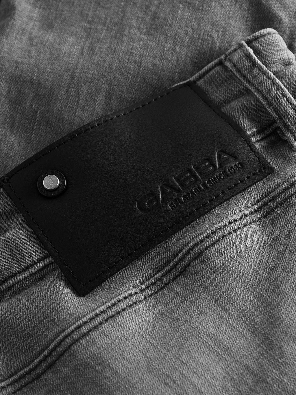 Close-up of the waistband on gray GABBA GABrey K3454 - Denim wash slim fit jeans, featuring a black leather patch with the embossed brand name and 