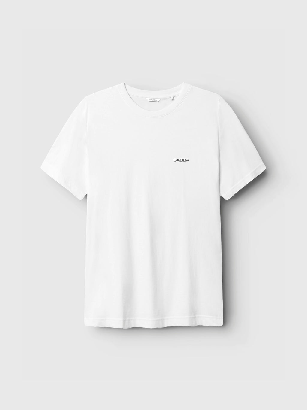 The Gabba GABdune Logo GOTS SS T-Shirt in white is a classic-fit tee, crafted from soft organic cotton with a silicone-washed finish. It features the word “GABBA” in small black print on the left chest and is shown against a light gray background.