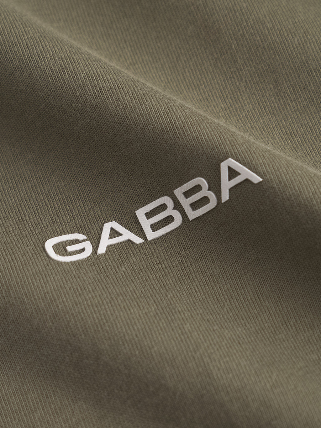 Close-up of Deep Lichen Green GABdune Logo GOTS SS T-Shirt by Gabba, featuring bold white 
