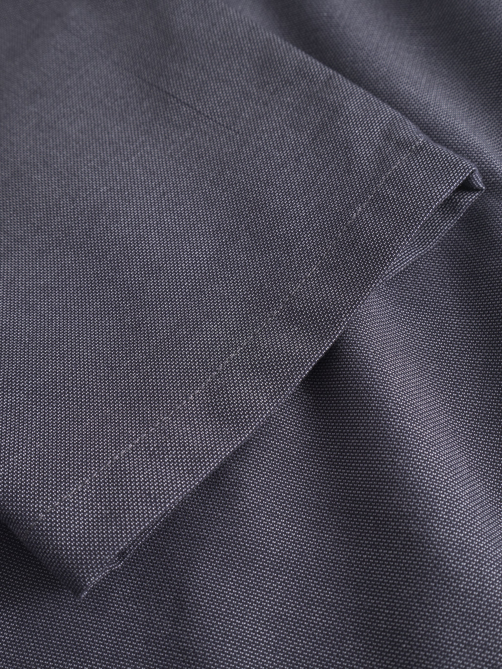 Close-up of navy fabric with visible weave texture and straight-stitched hem, highlighting the folded edge of Gabba's Napoli 19 Carre pants for a classic look and comfortable fit.