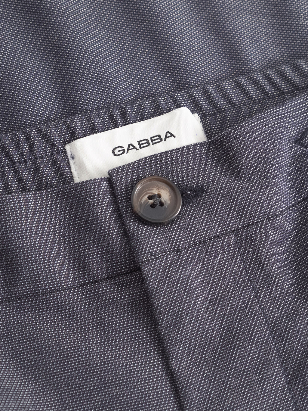 Close-up of Monza Button Carre - Navy trousers by Gabba with a visible white label inside the waistband, highlighting their versatile style, perfect for relaxed straight pant looks.