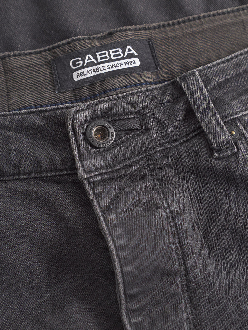 Close-up of GABBA GABrey Thor Jeans in denim wash, highlighting the waistband label, button, belt loops, and stitching details for a laid-back vibe.