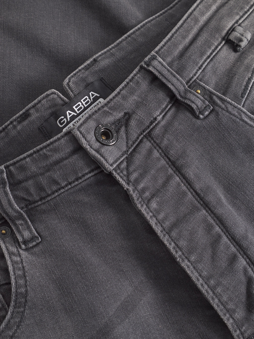 Close-up of the waistband and button on GABBA’s GABalex Thor Cropped Jeans in denim wash, showing the brand label above the zipper and modern fit details for a contemporary style.