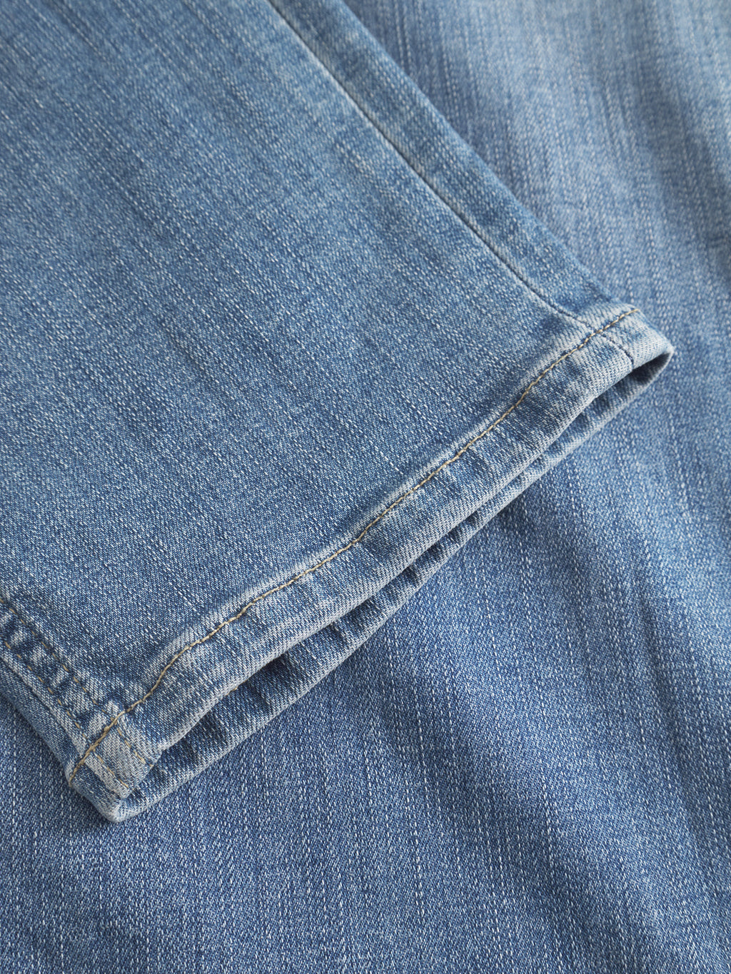 A close-up of the hem of GABBA GABjones K2615 Lt. - Denim wash jeans, highlighting the textured blue denim, detailed stitching, and super-stretch fabric for enhanced flexibility.