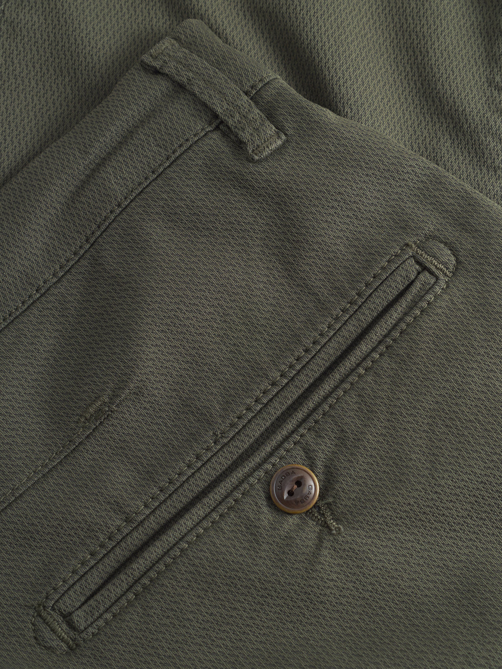 Close-up of the GABBA GABpaul K3280 Dale Chino in Army, showcasing textured olive green fabric, a back pocket with button closure, fabric loop above the pocket, and a modern slim leg opening.