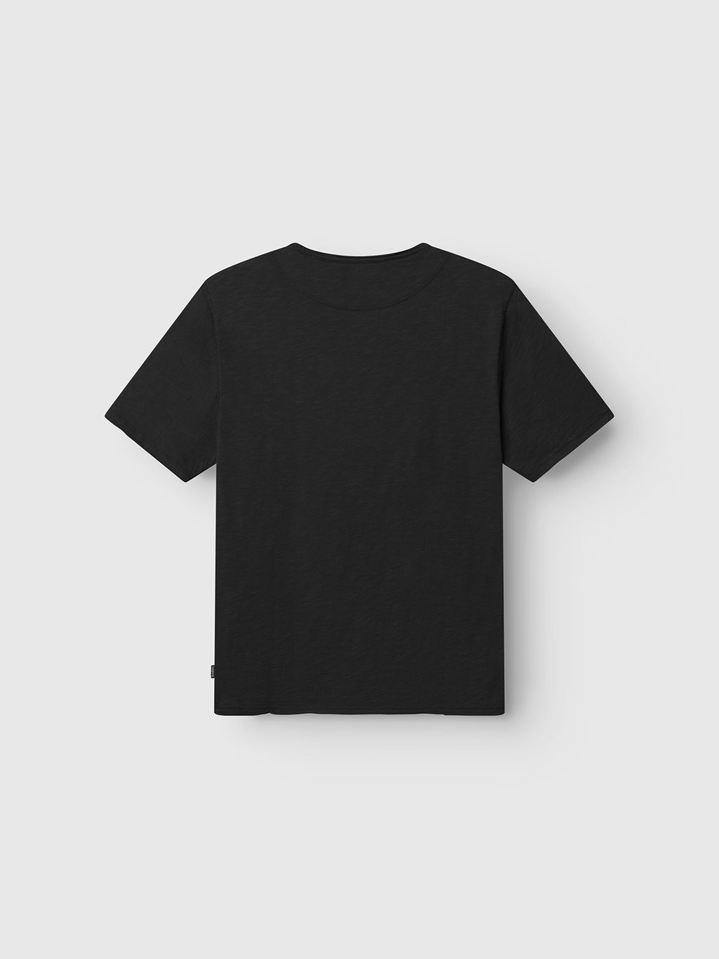 The Gabba GABkostant New SS - Meteorite, a 100% cotton black slub short-sleeve t-shirt, is shown flat from the back on a light gray background.