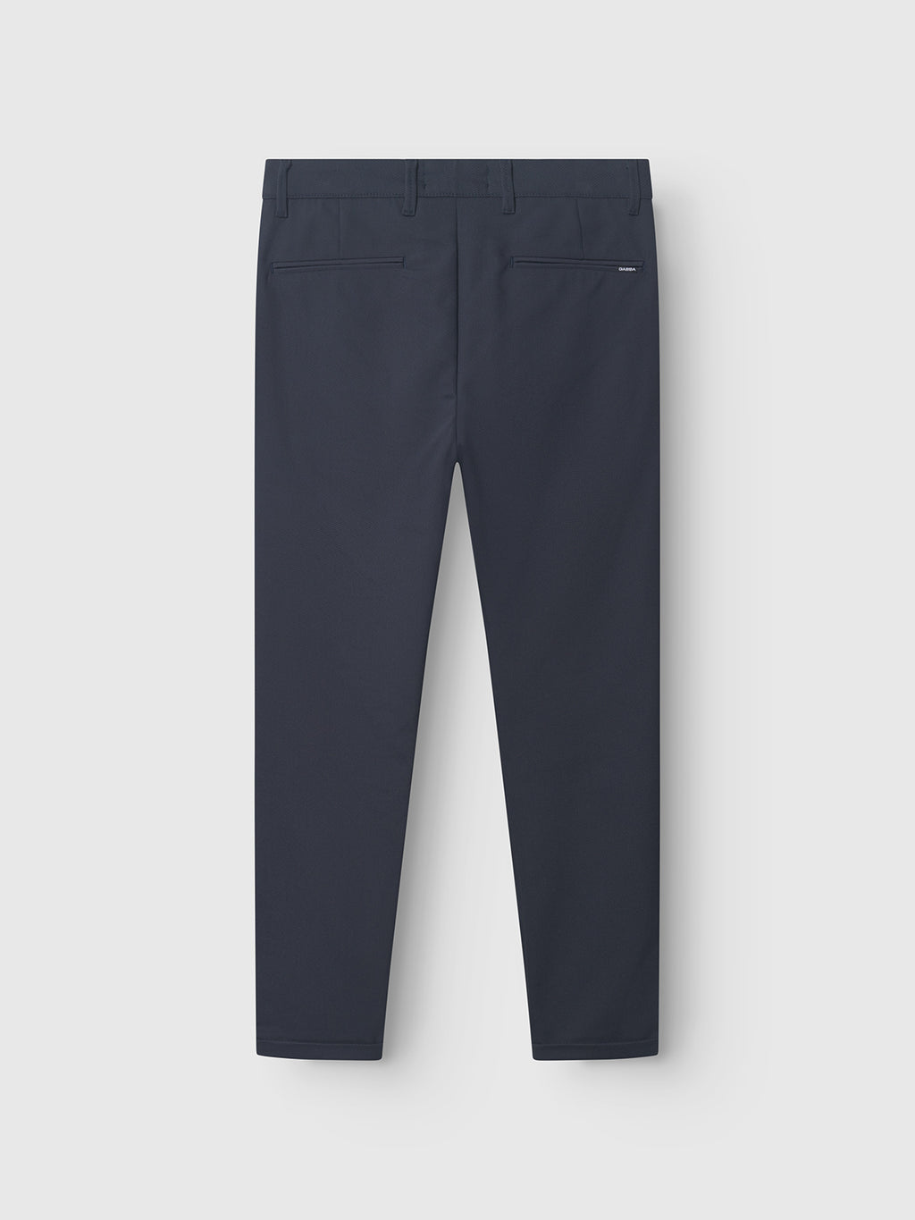 Back view of GABBA Pisa Small Dot - Navy pants, featuring two back pockets and belt loops. Made from high-stretch cotton-blend fabric, they present a modern metro style against a plain light gray background.