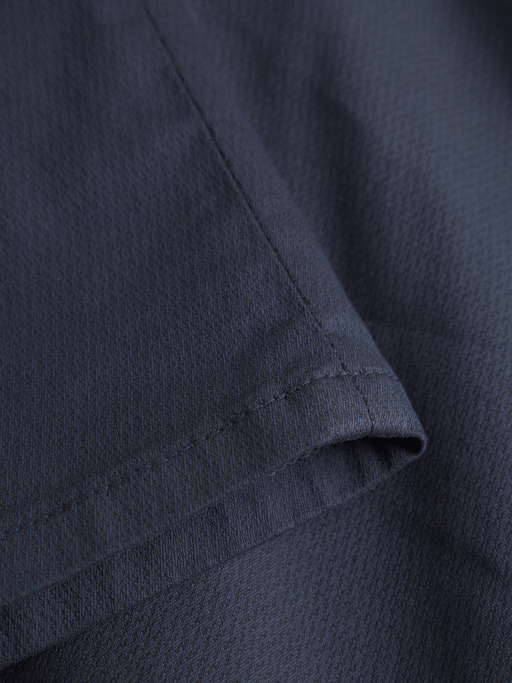 Close-up of dark blue fabric with subtle texture and visible stitching, highlighting the hem of the GABBA GABpaul K3280 Dale Chino in Navy, featuring signature French pockets.