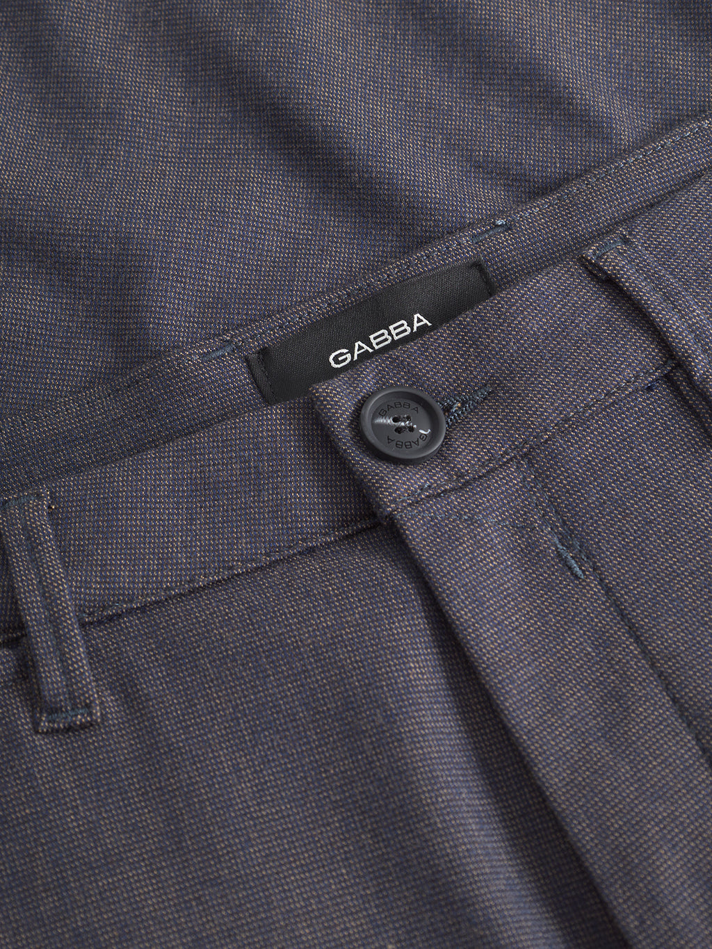Close-up of Gabba's Paul Domo - Dark Navy Melange slim chino featuring textured fabric, branded buttons, belt loops, French pockets, and an inner waistband with a visible black GABBA label.