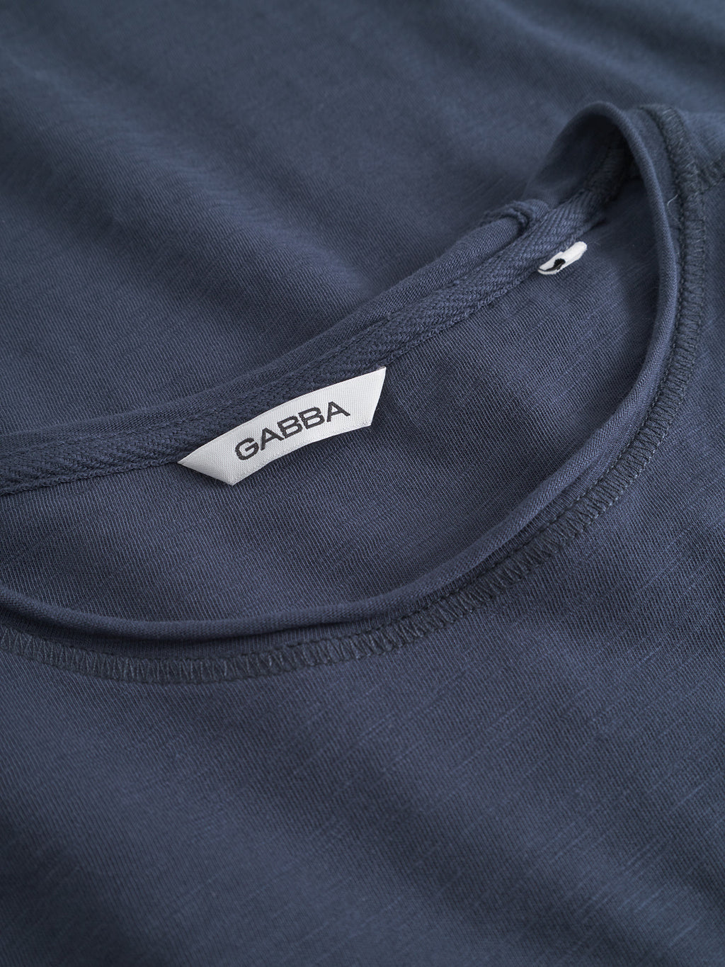 A close-up of the Gabba GABkostant New SS t-shirt in navy, neatly folded to showcase its slub fabric texture, precise stitching, and a white neckline tag branded with Gabba.