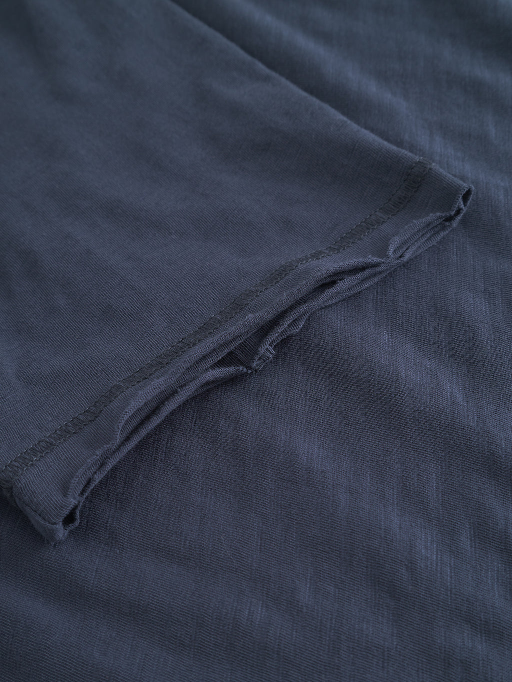 A close-up of the sleeve and body of the Gabba GABkostant New SS - Navy t-shirt highlights its textured 100% cotton fabric and detailed stitching.