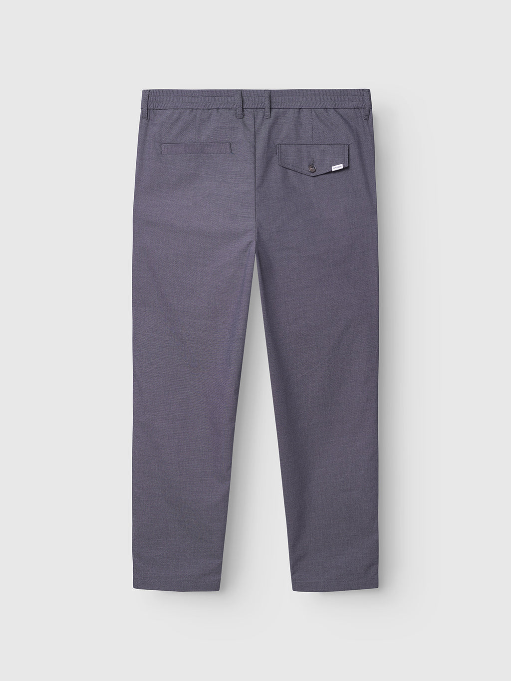 Monza Button Carre pant in navy by Gabba, shown from the back with two back pockets—one with a buttoned flap and white tag, the other a simple slit. Features belt loops, elastic waist, and a straight-leg fit for versatile style.