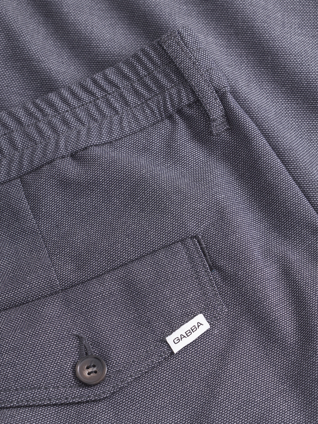 Close-up of Gabba's Monza Button Carre - Navy pants. Features a back pocket with button, a small white Gabba label, and detailed waistband and seams, highlighting the versatile style of these relaxed straight-fit pants.