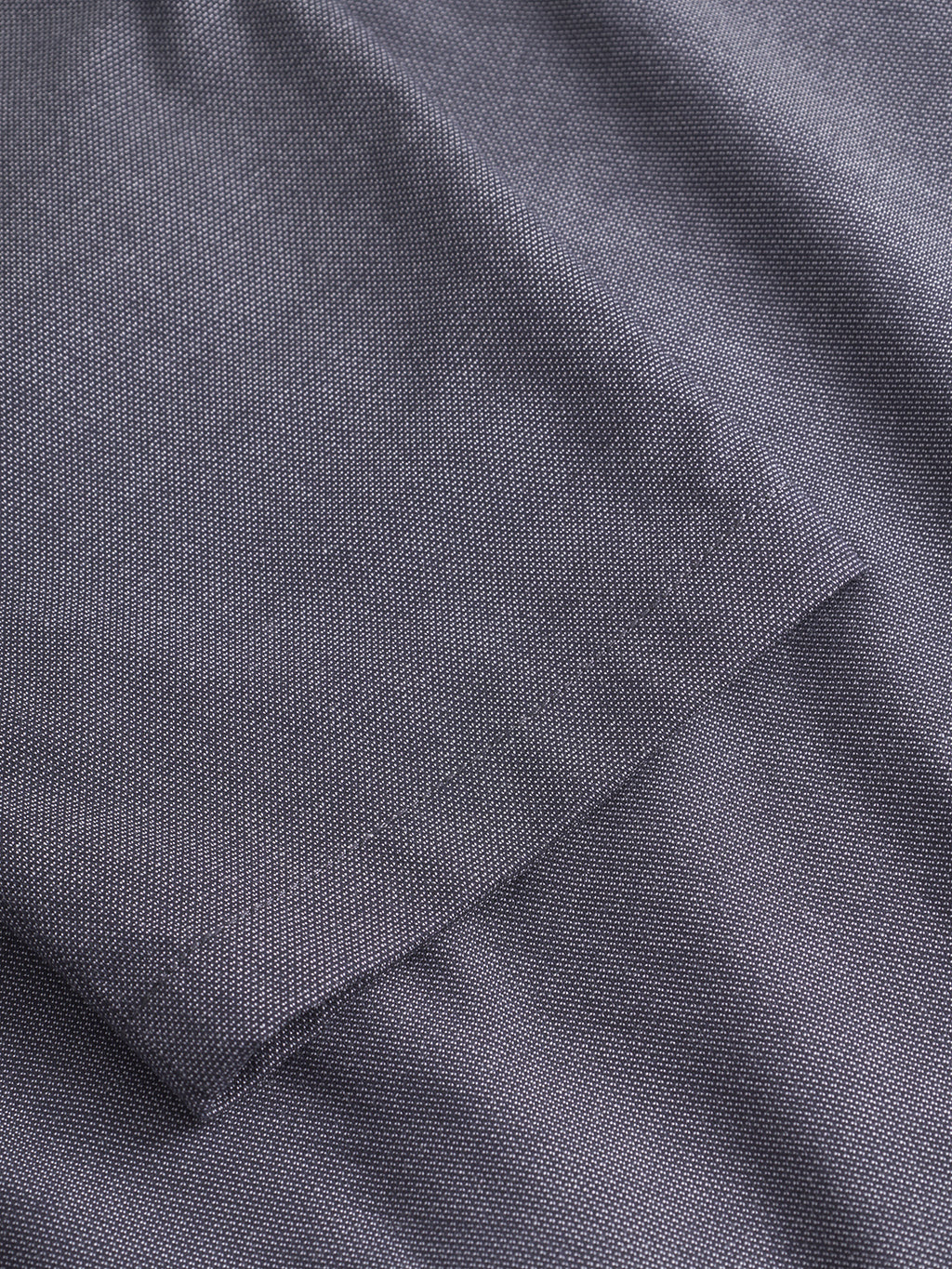 A close-up of the Monza Button Carre - Navy by Gabba shows its fine, textured weave—perfect for relaxed straight pants that deliver versatile style.
