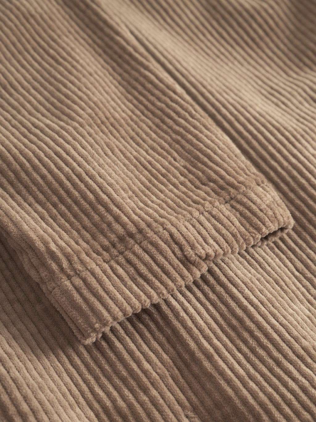 Close-up of Gabba Libre AX Cord - Sand reveals distinctive raised, parallel ridges and a soft texture—perfect for a brushed stretch corduroy overshirt.