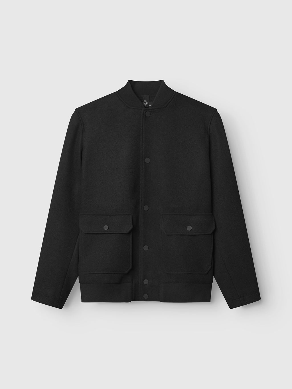 The Gabba Orta Wox - Black is a collarless bomber jacket featuring snap buttons and large flap pockets. Breathable and windproof, this stylish black jacket is shown against a plain light gray background.