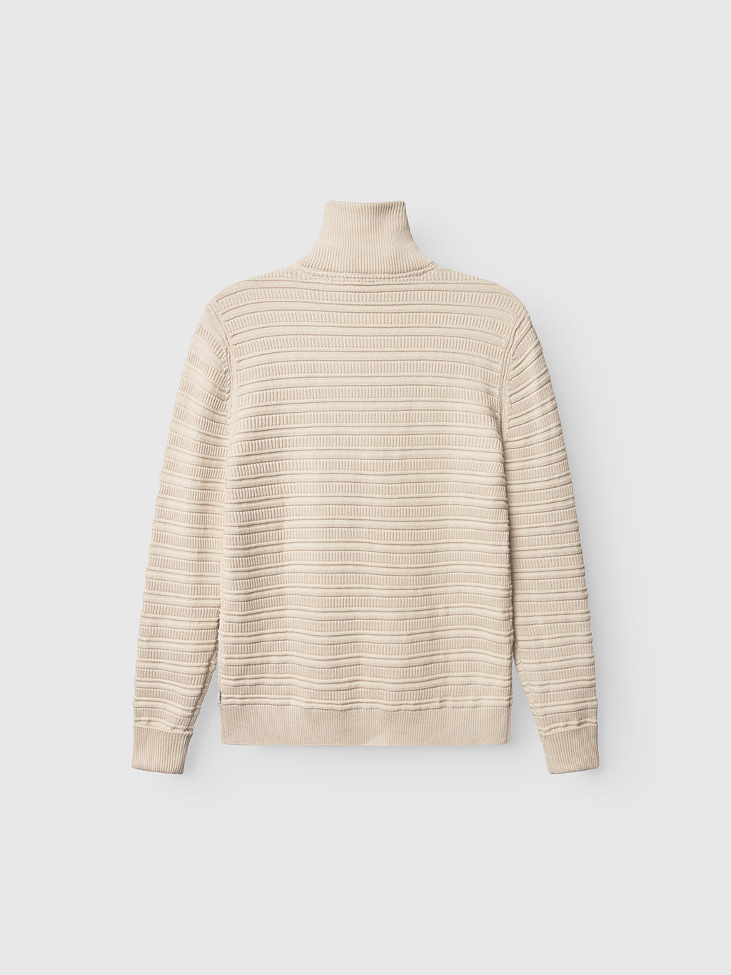 The Gabba Iwaki Buco LS in White Almond is a cream-colored, long-sleeve ribbed cotton jumper shown flat on a white background, highlighting the back with horizontal textured stripes.