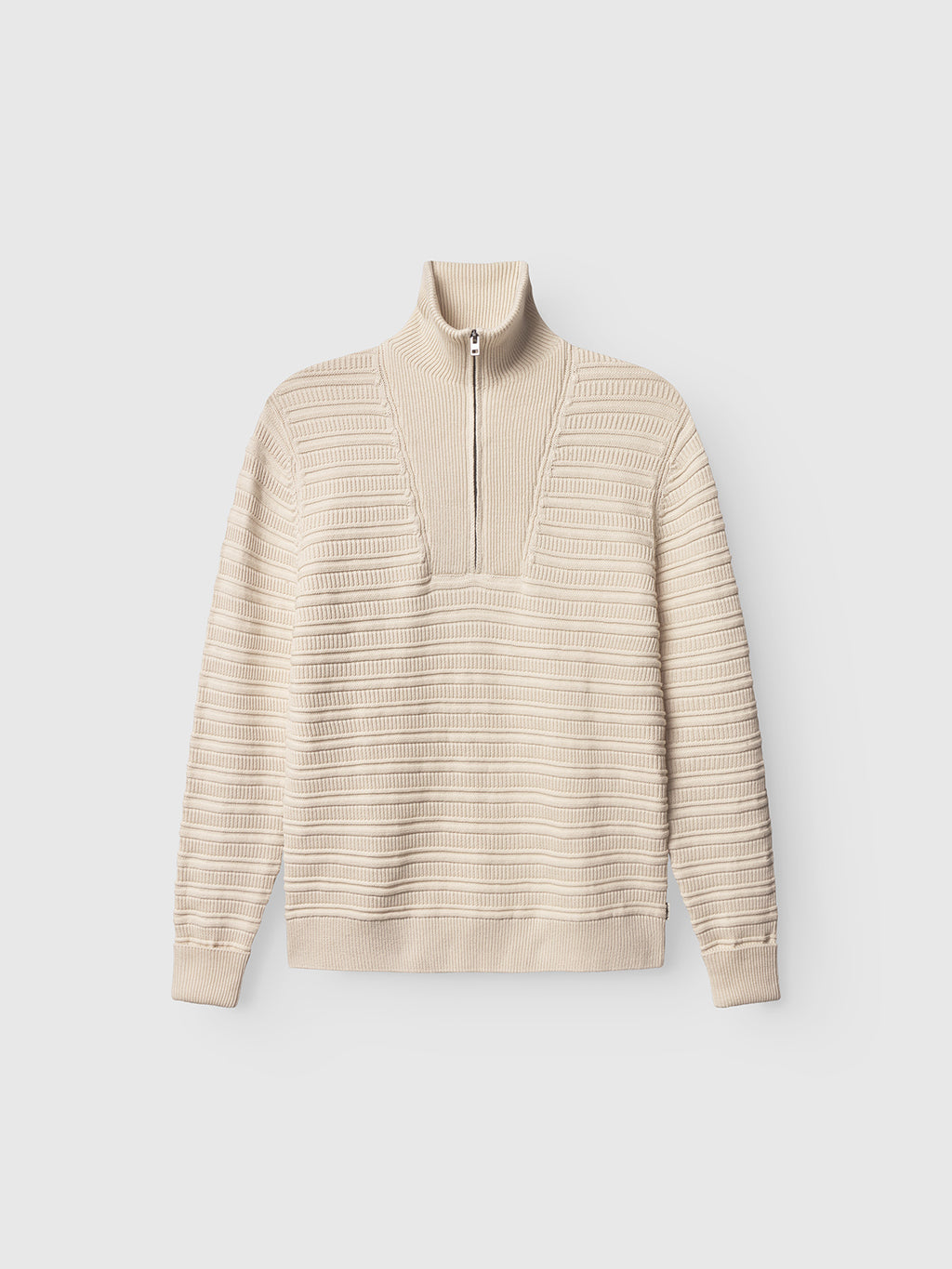 The Gabba Iwaki Buco LS - White Almond is a beige ribbed knit cotton jumper with a high collar, half-zip front, horizontal stripes, and long sleeves, shown laid flat on a plain white background.
