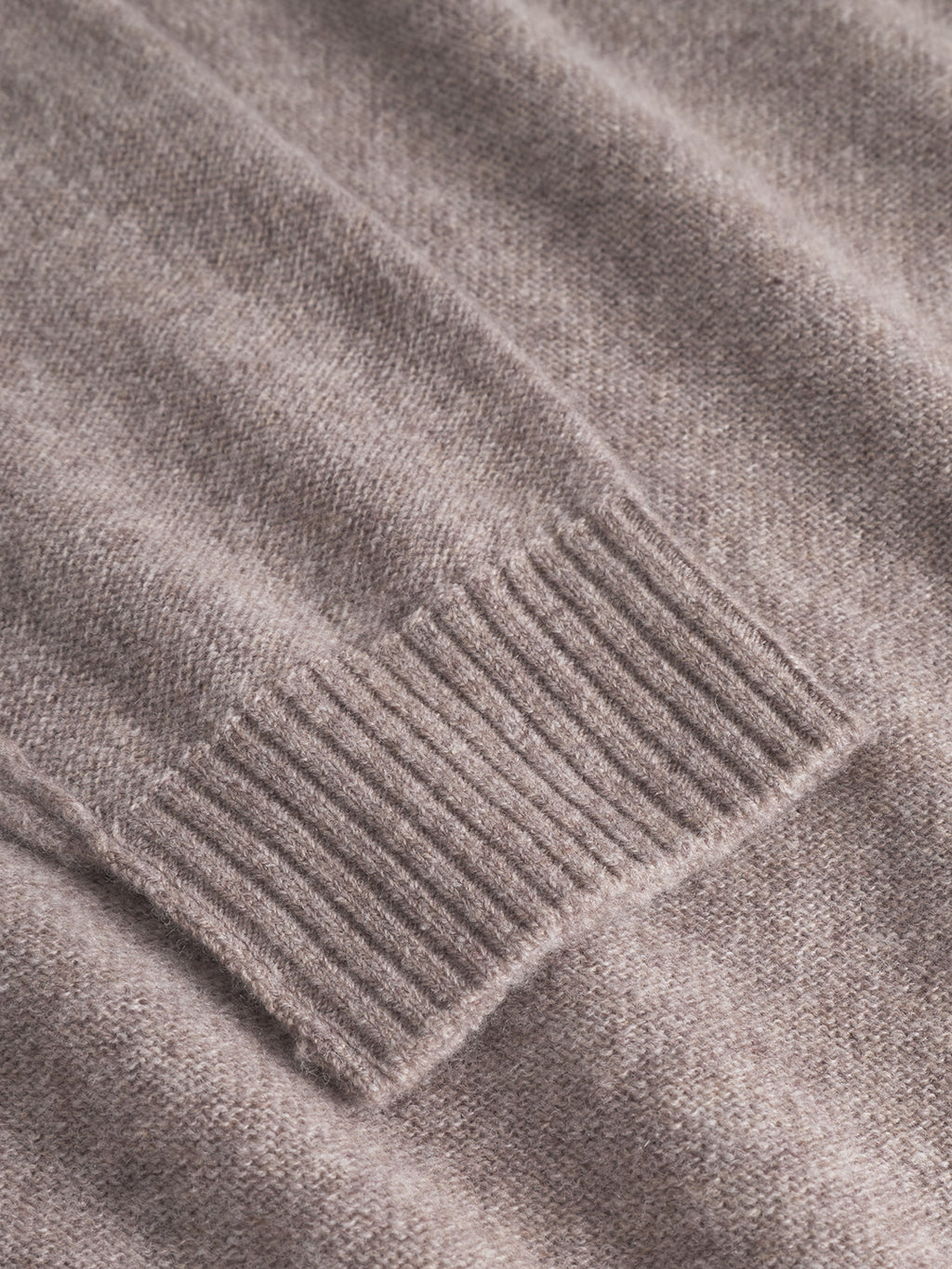 Close-up of the ribbed cuff and smooth sleeve of the Gabba Tokota Aico LS sweater in light brown, showcasing its fine merino wool texture.