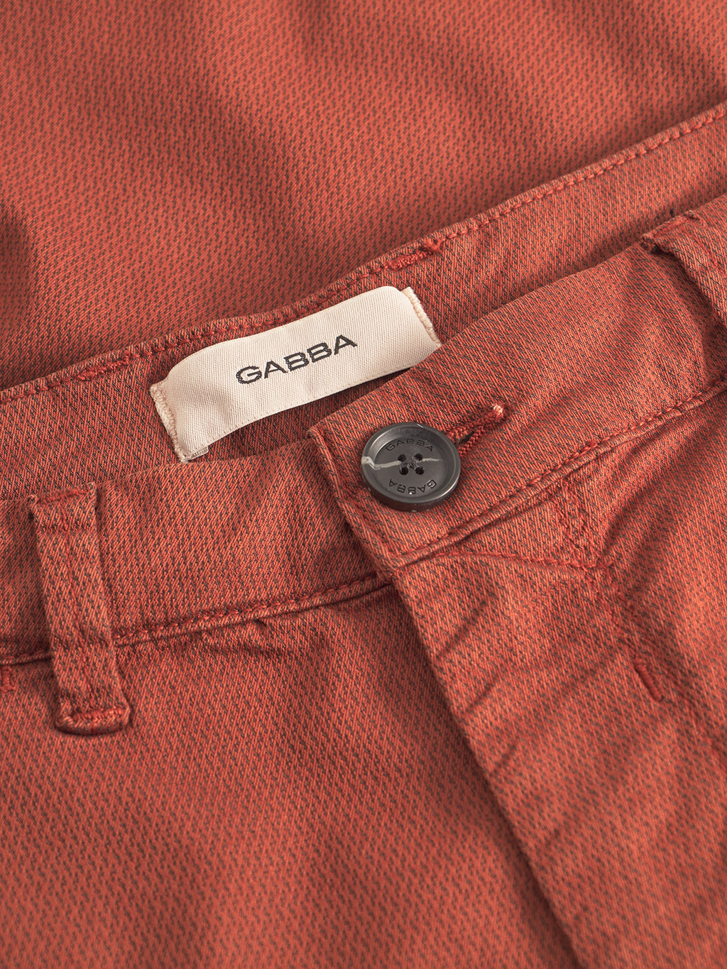 Close-up of GABpaul K3280 Dale Chino in Brown Rust by Gabba, featuring French pockets, a black button, and a white GABBA label sewn into the waistband.