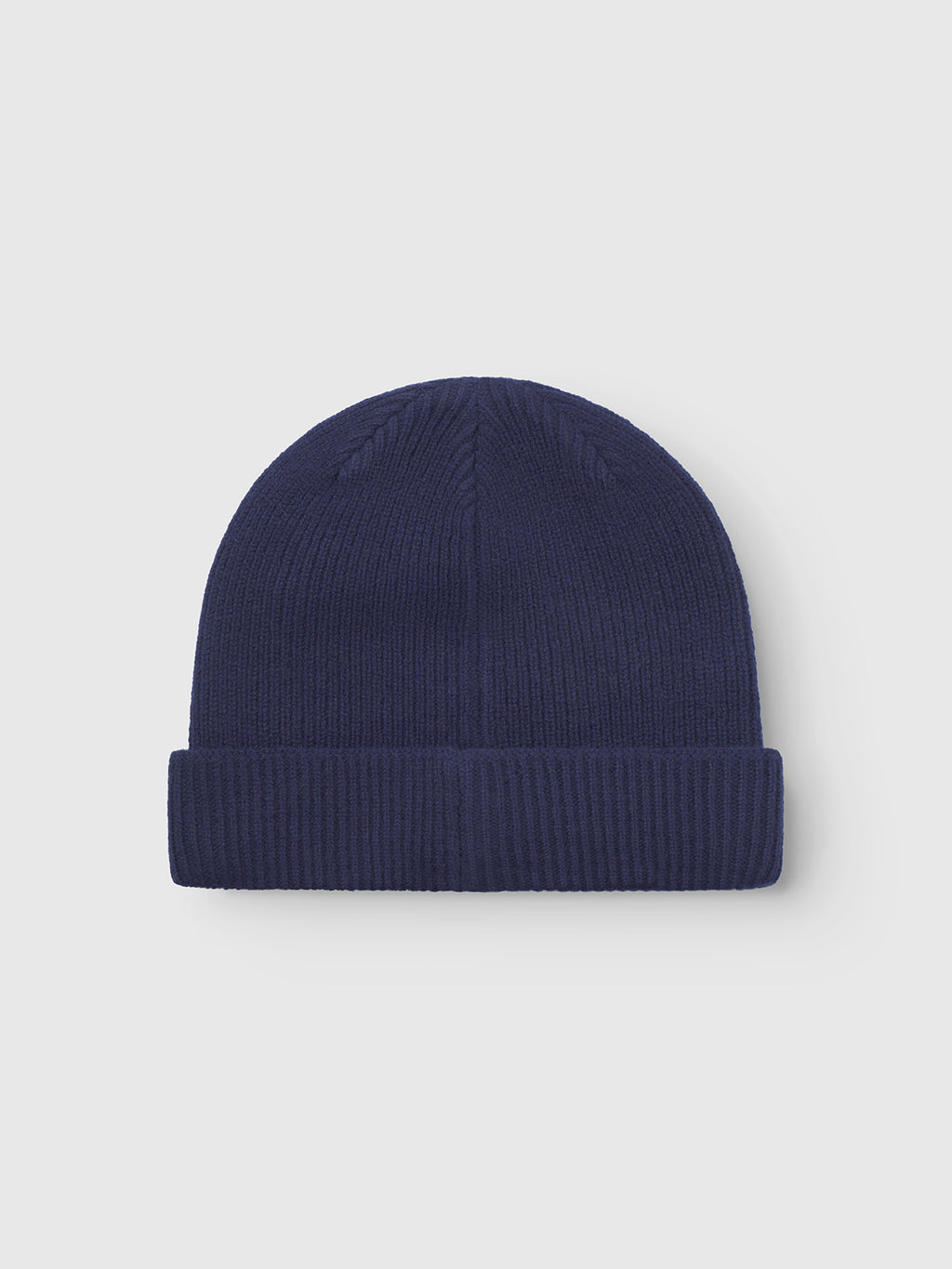 The Gabba Biella Aico beanie in navy features a ribbed knit and folded brim, shown against a plain light gray background.