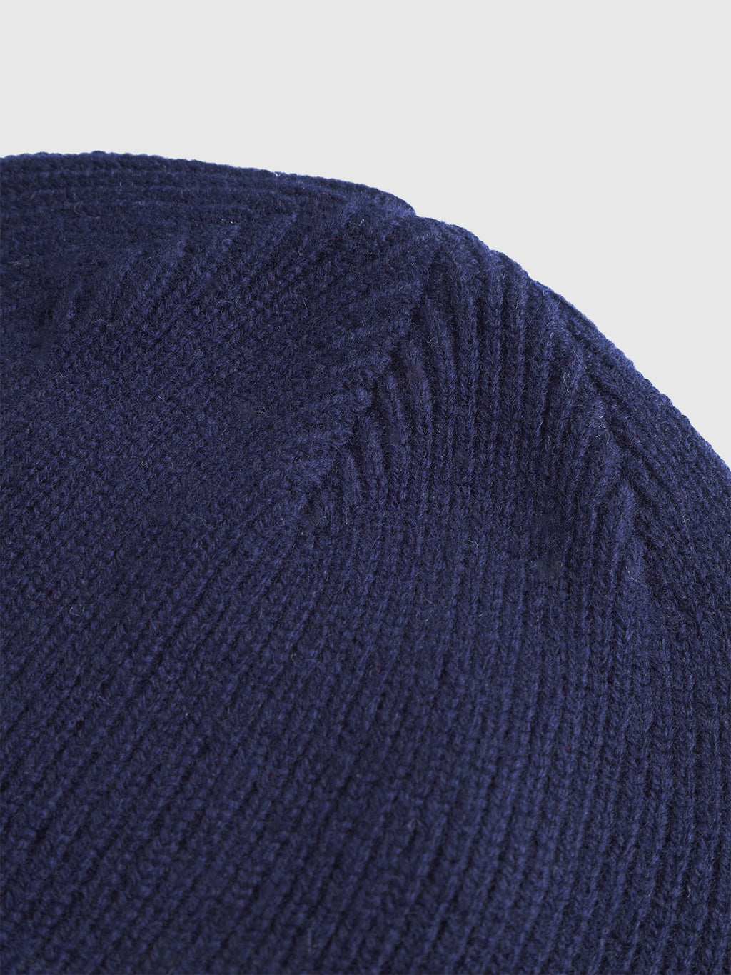 Close-up of the Gabba Biella Aico - Navy beanie, showcasing its merino wool ribbed knit texture and diagonal stitching pattern for enhanced warmth and style.