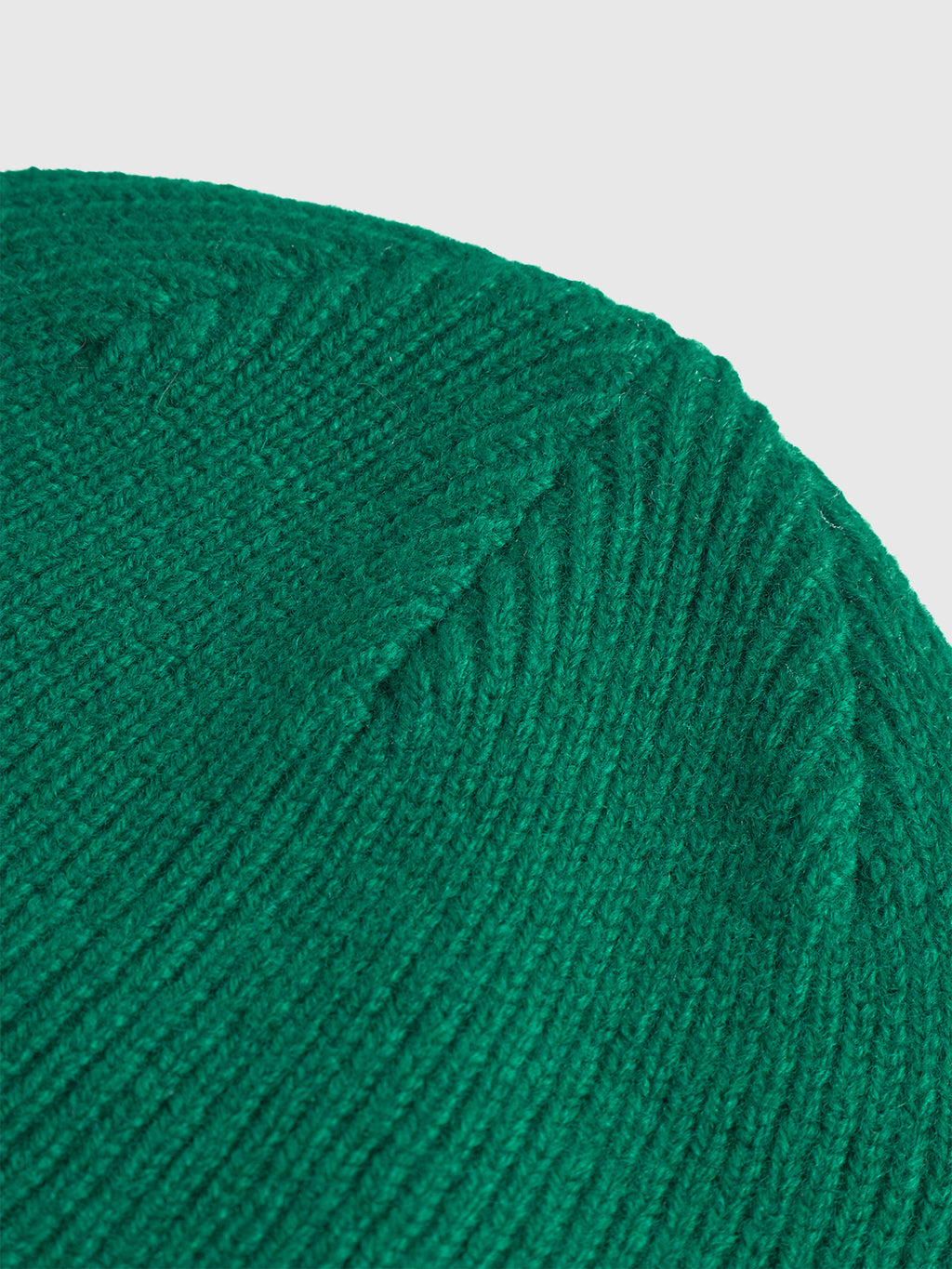 Close-up of the Gabba Biella Aico - Green ribbed knit beanie, highlighting its detailed stitching and texture, set against a white background.